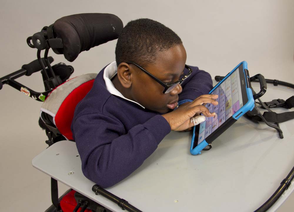 boy using touch screen device